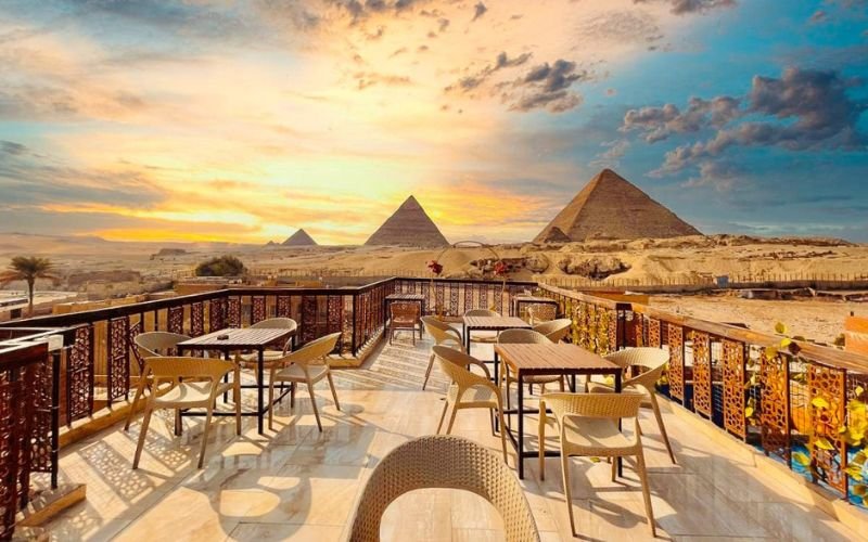 Rooftop café at one of the best hotels in Cairo with a view of the Great Pyramids at sunset.